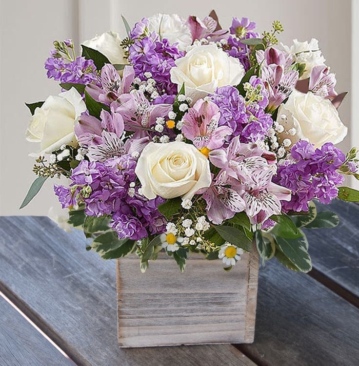Lovely Lady (Lavender and White) - Hand-designed inside a rustic wood cube vase with cascading greenery all around, it’s a wonderful way to express the sentiments you have inside your heart