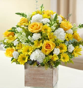 Sun Glare Bouquet  -  A vivid yellow and white bouquet of roses, snapdragons, alstroemeria, carnations and more is arranged in a classic Rustic Cube, definitely impresses with its beauty Bouquet. Surprise someone with beautiful  flowers that are sure to brighten up any room this season
