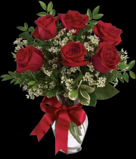 Red roses in a clear glass vase with a red ribbon