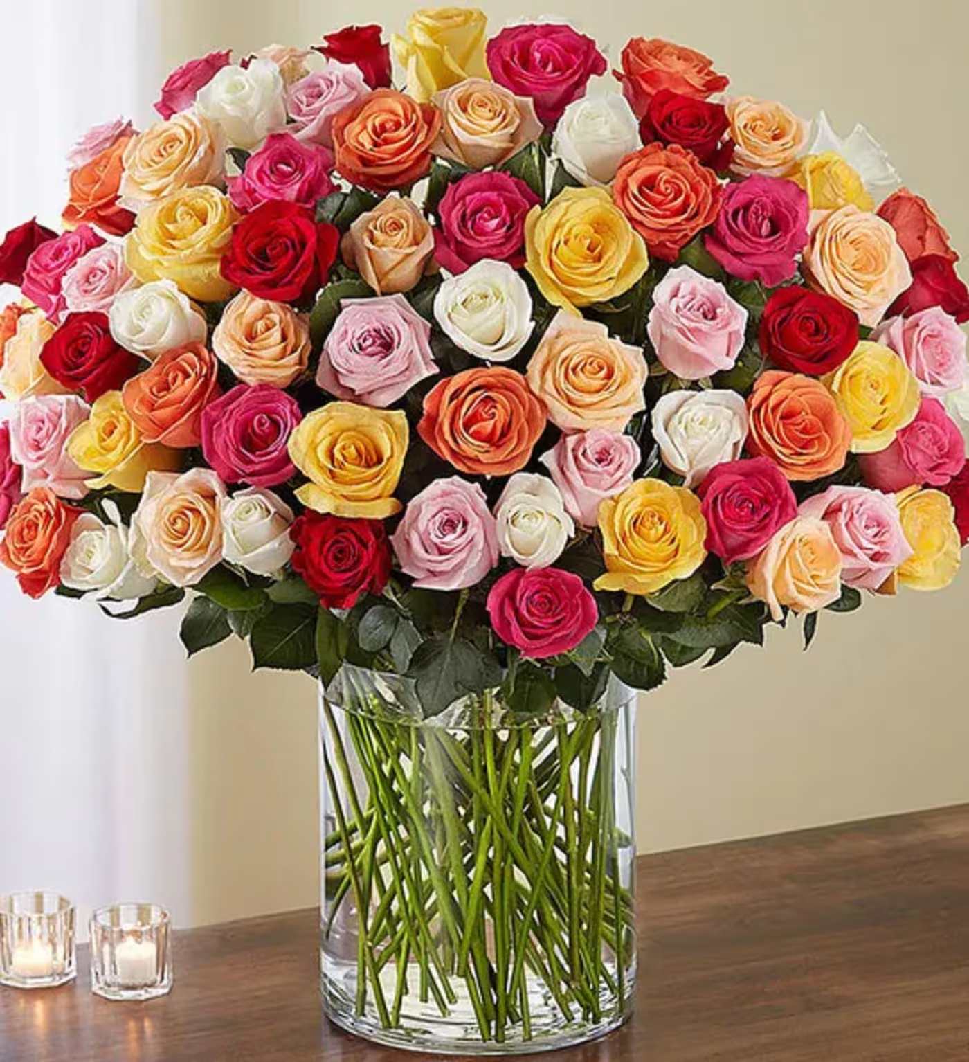Large bouquet of multicolored roses in a clear glass vase