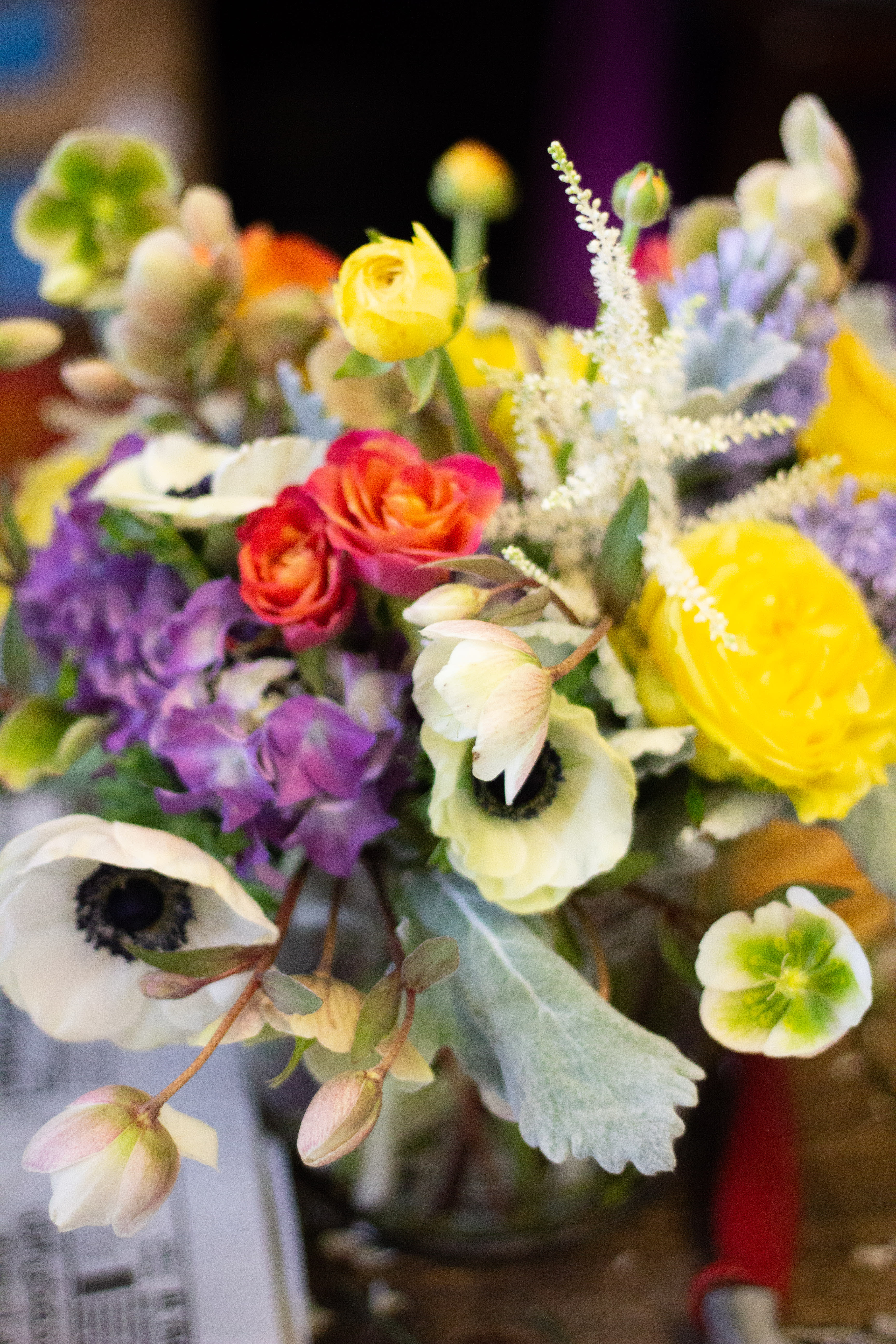 Bright  - A cheerful bouquet of anemones and roses, as well as soft textures from traditional premium greenery. 