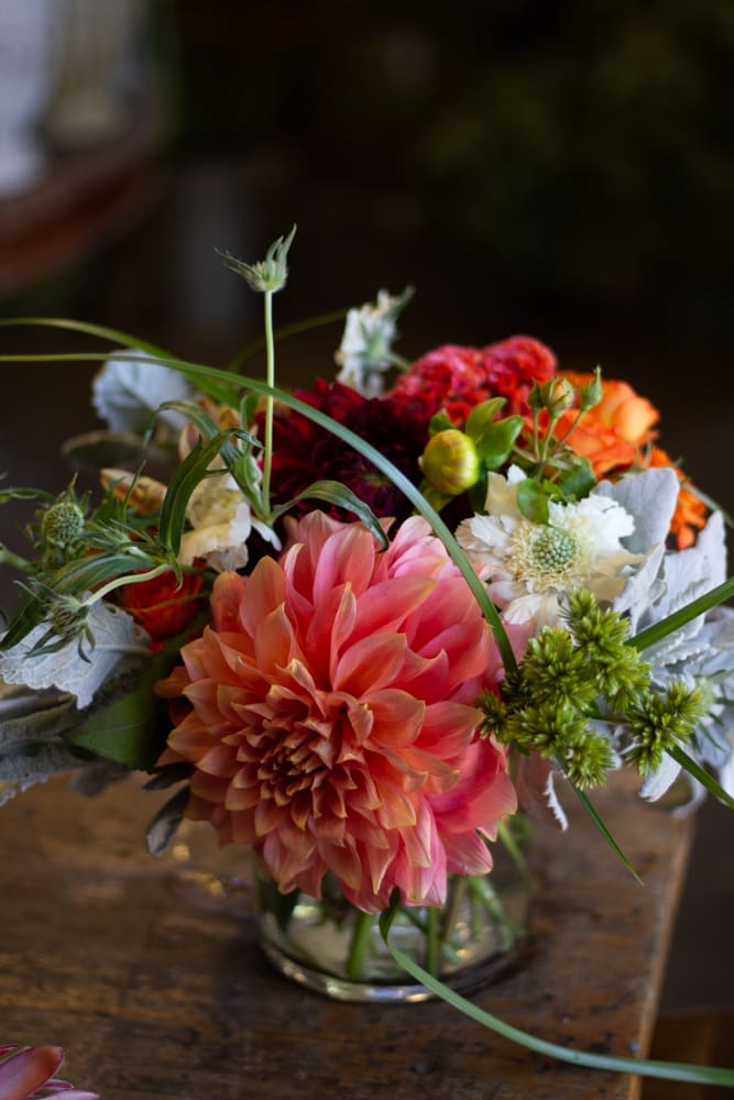 Mixed bouquet with a large pink dahlia in a glass vase