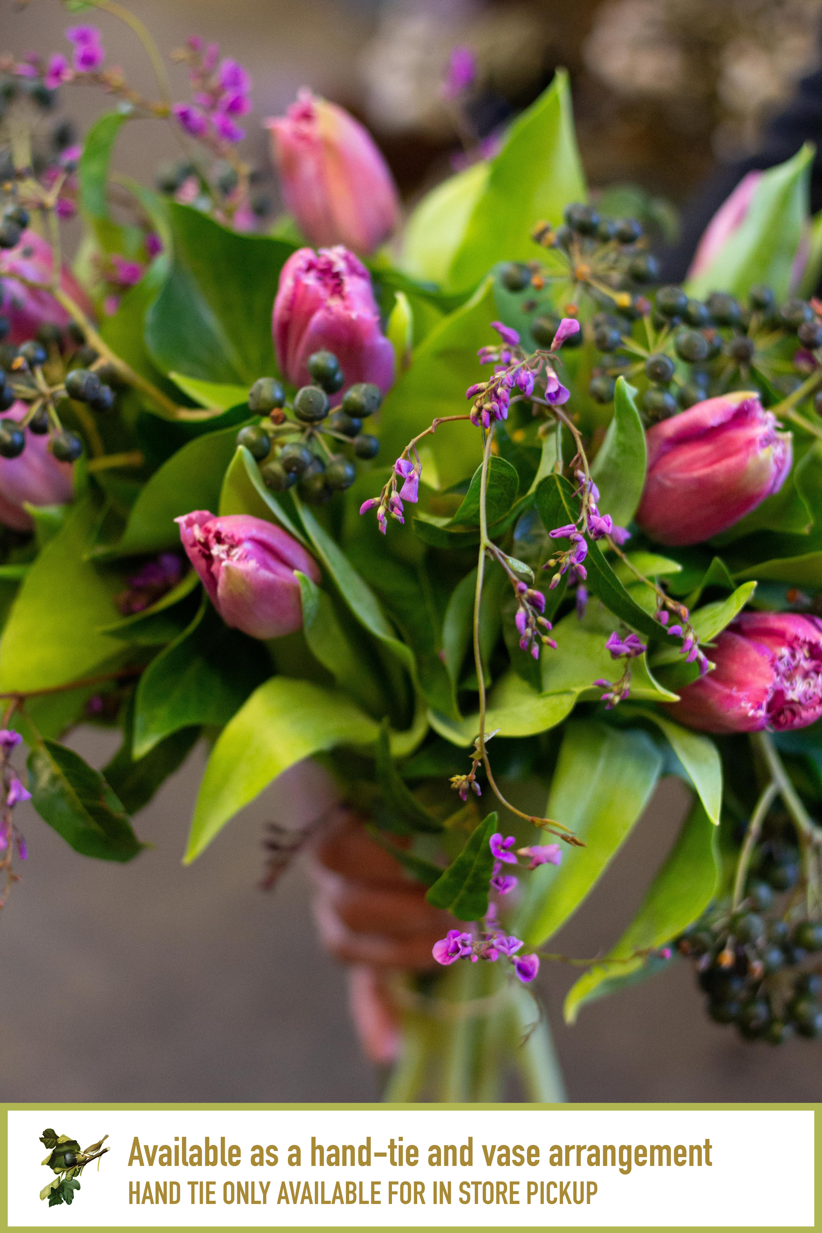 Pink tulips with purple accents and green foliage in a bouquet