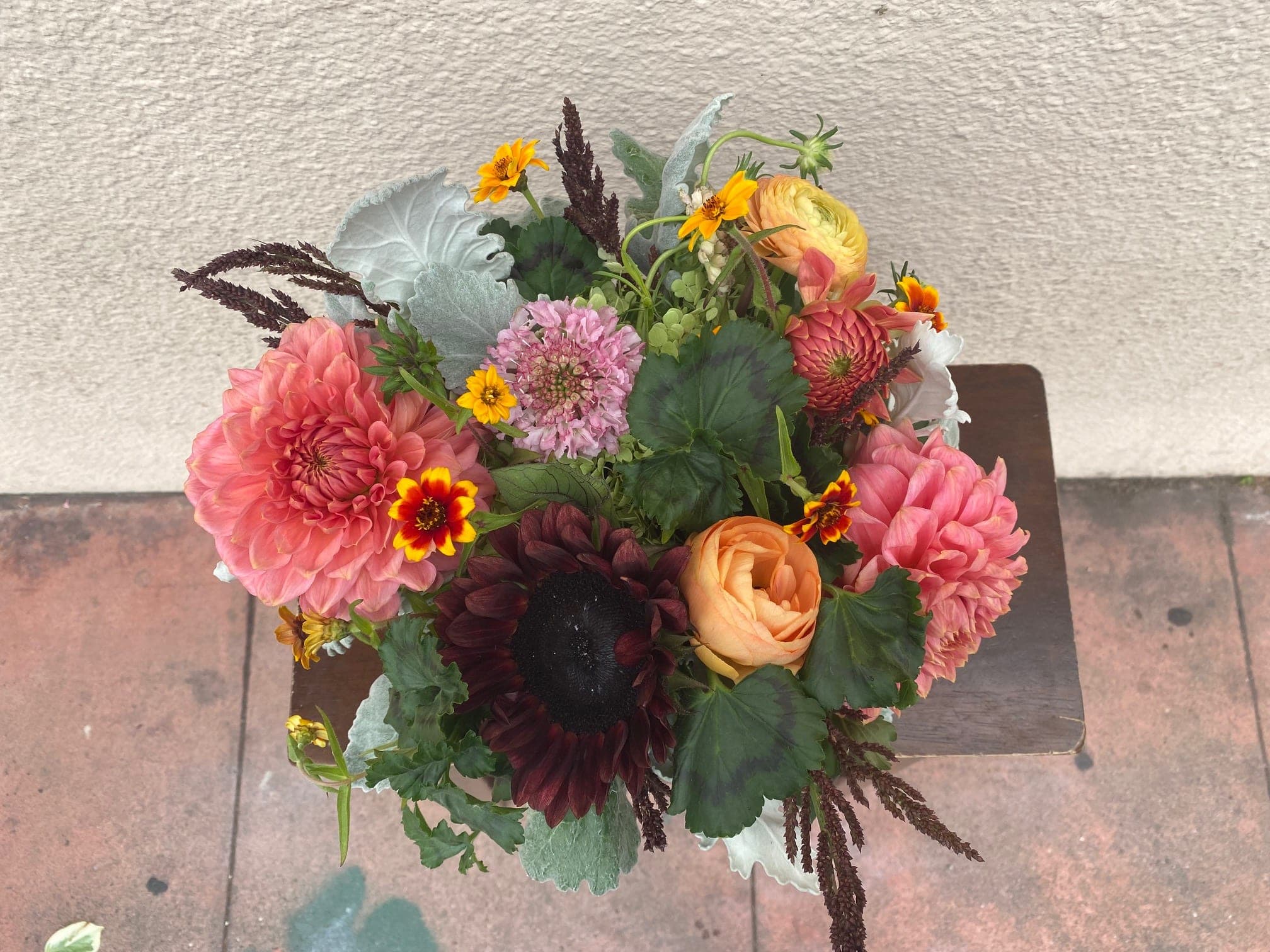 Mixed bouquet with pink and peach blooms in a compact arrangement
