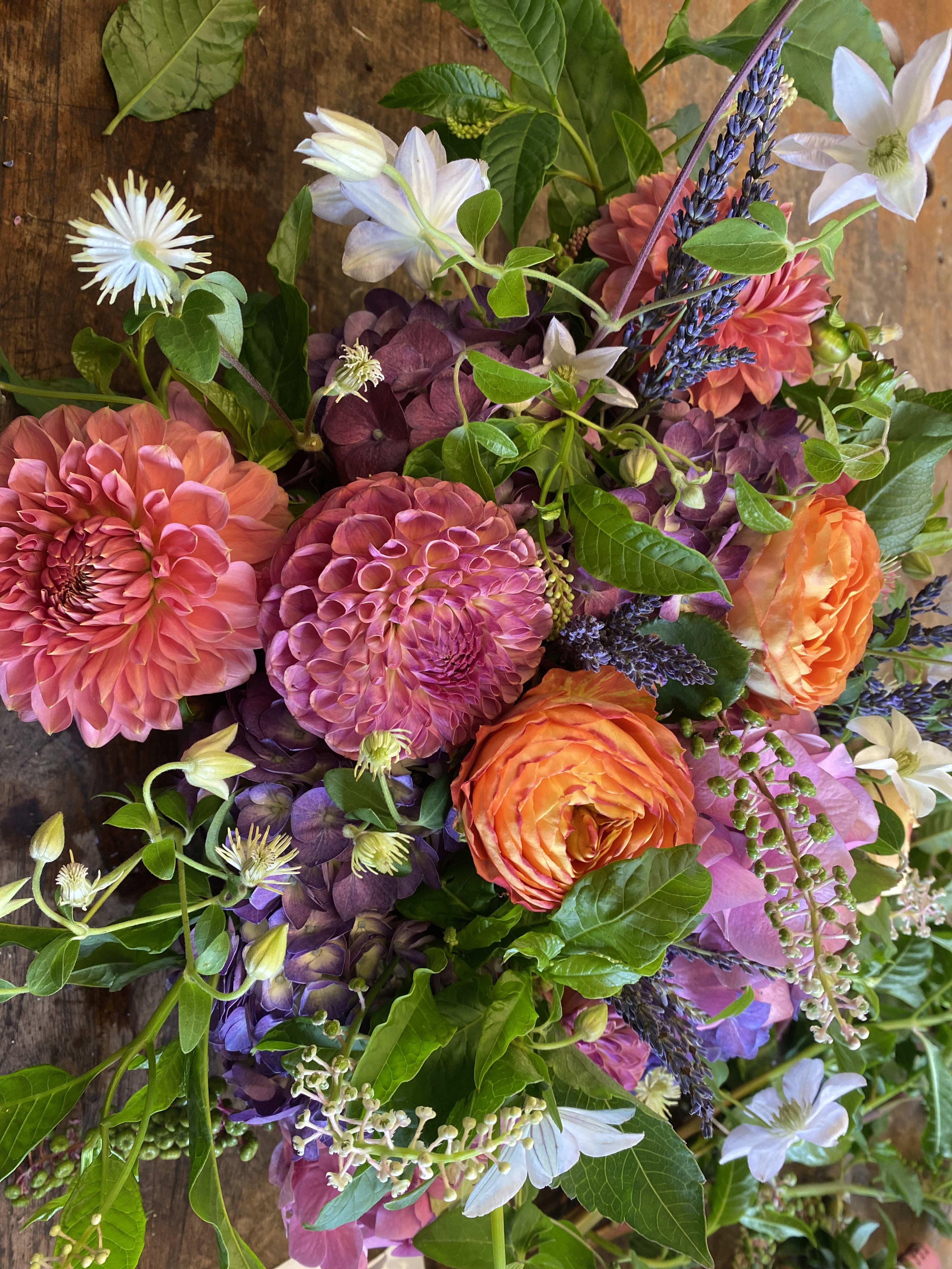 Bouquet of pink, orange, and purple flowers with white blooms
