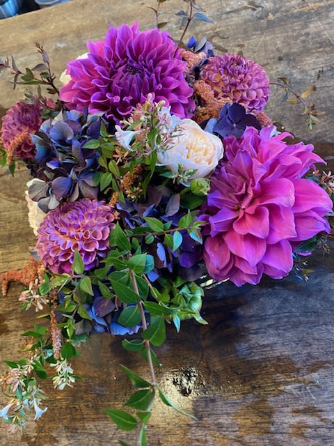 Bouquet of purple dahlias and blue hydrangeas with white blooms