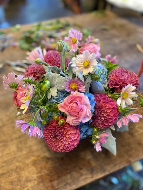Mixed bouquet of pink, blue, and white flowers