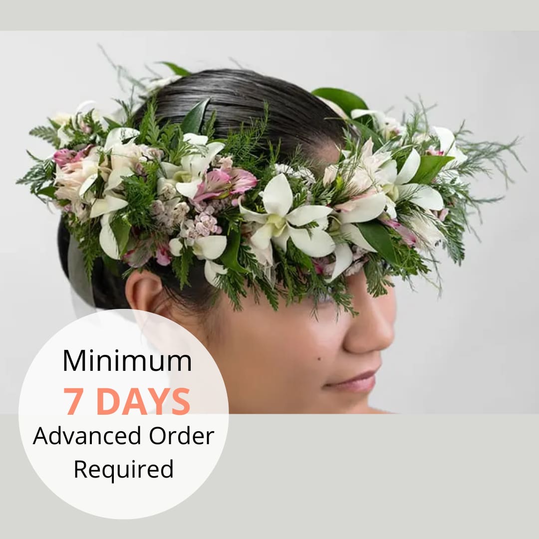 White and pink flower crown with lush foliage worn around a woman's head.
