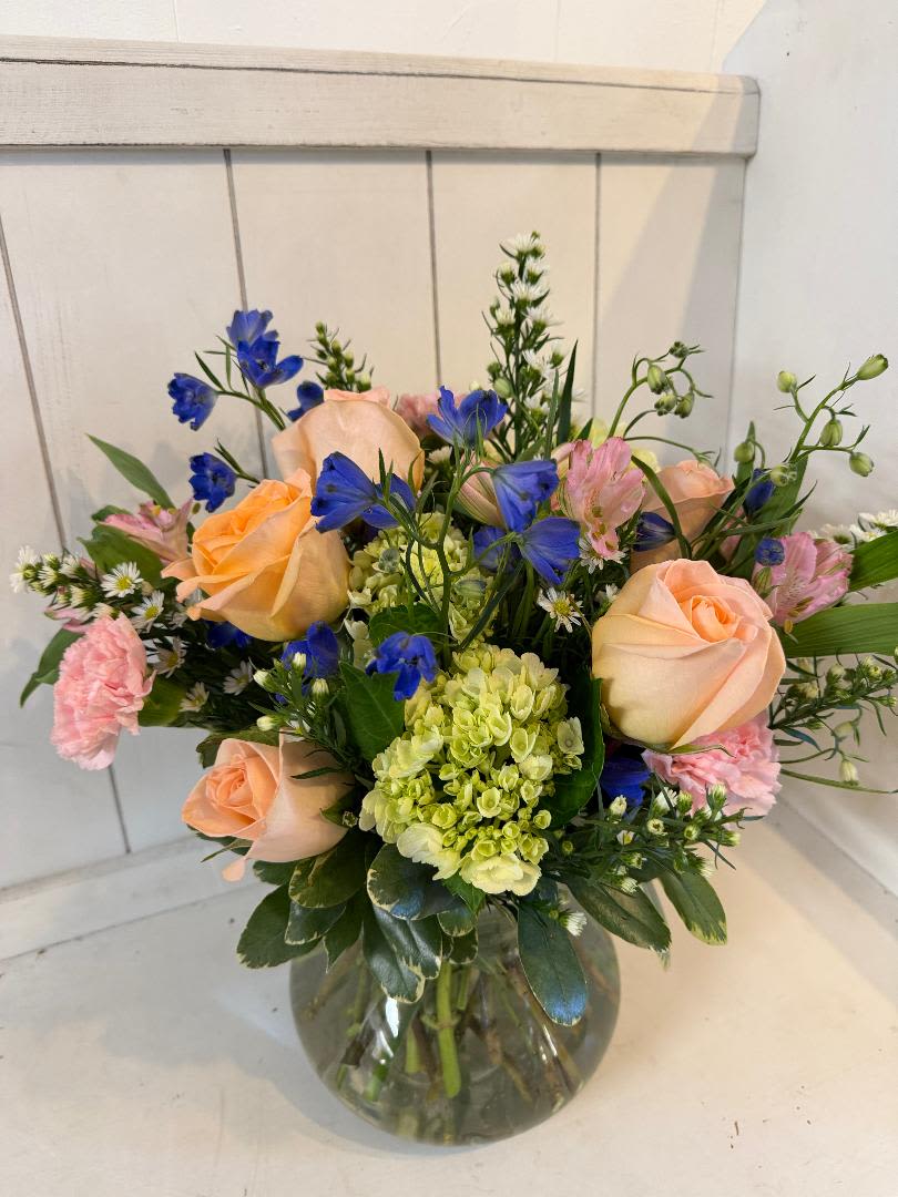 Rosie Posie's - clear glass rosie posie vase, filled with roses, delphinium, hydrangeas, filler, carnations, alstroemeria.