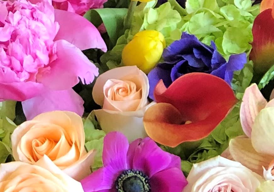 Mixed bouquet with pink roses, calla lilies, and a purple anemone
