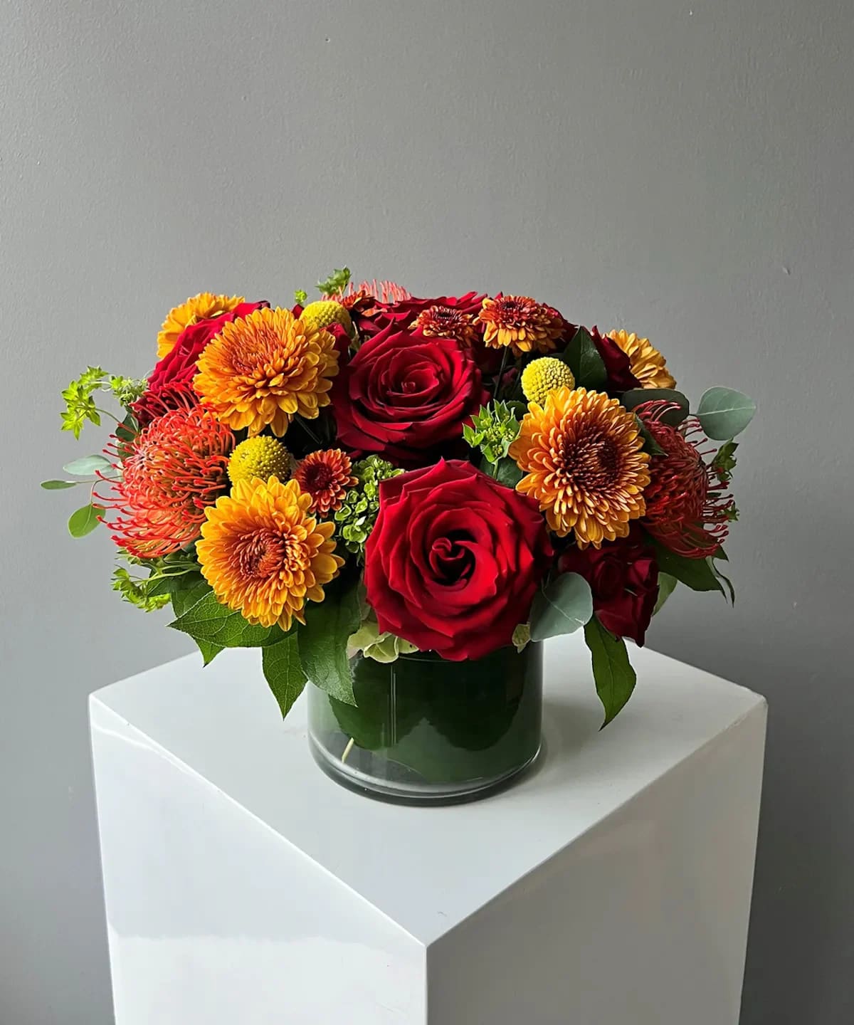 Autumn Blooms - Fun autumn long lasting blooms designed in a low vase! 