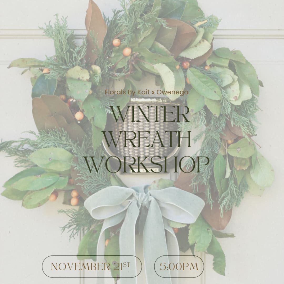 Winter wreath with greenery and a pale ribbon bow
