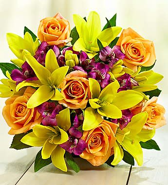 Bouquet of orange roses and yellow lilies with purple accents