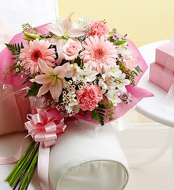 Pink and white mixed bouquet wrapped in pink paper with a ribbon
