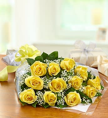 Bouquet of yellow roses with baby's breath wrapped in paper