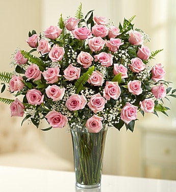 Pink roses arranged in a clear glass vase