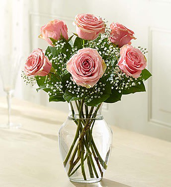 Pink roses arranged in a clear glass vase