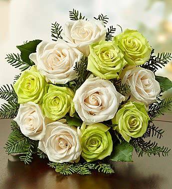 Bouquet of white and lime green roses with dark greenery