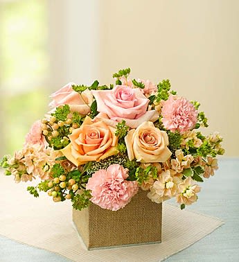 Pink and peach roses with carnations in a square box