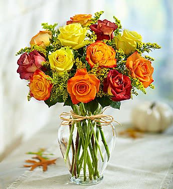 Bouquet of multicolored roses in a clear glass vase