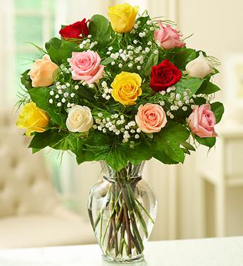 Bouquet of multicolored roses in a clear glass vase