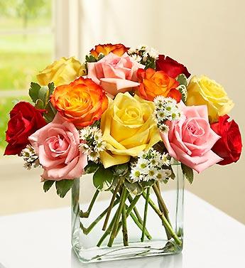 Bouquet of multicolored roses in a clear glass vase