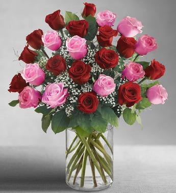 Bouquet of red and pink roses in a clear glass vase