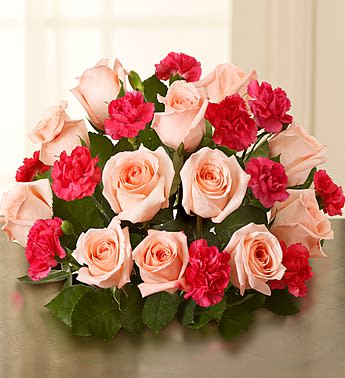 Bouquet of pale pink roses and bright pink carnations