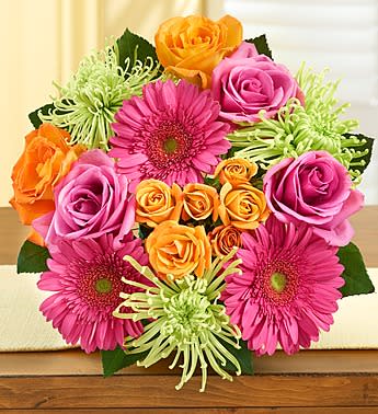 Bouquet of pink and orange roses with magenta daisies