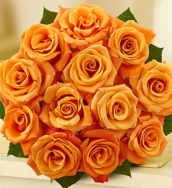 Bouquet of orange roses with a few green leaves