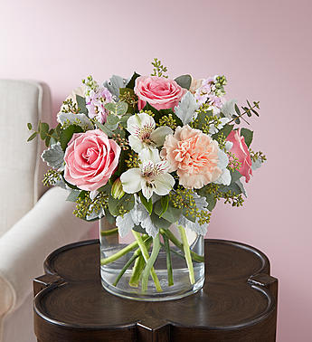 Pink and white bouquet in a clear glass vase