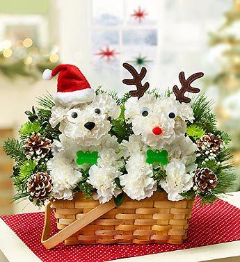 Basket arrangement with two white flower animal figures and Christmas accents