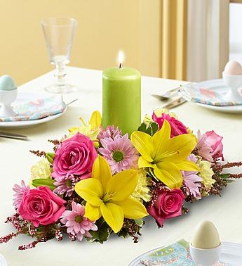 Bright floral centerpiece with pink roses and yellow lilies on a table