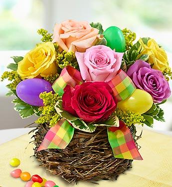 Colorful roses arranged in a woven basket with pastel Easter eggs