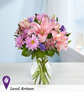 Pink and purple mixed bouquet in a clear glass vase