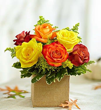 Bouquet of multicolored roses in a burlap-wrapped box