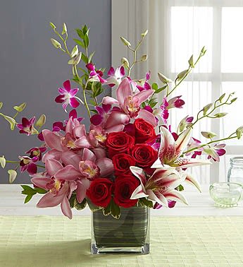 Pink lilies and red roses in a glass vase