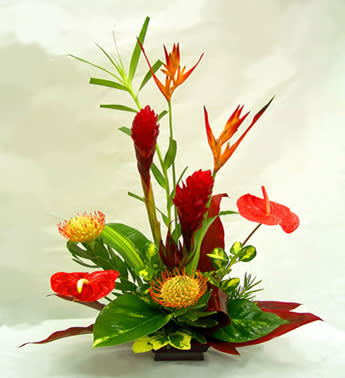 Tropical floral arrangement with red anthuriums and orange bird-of-paradise blooms