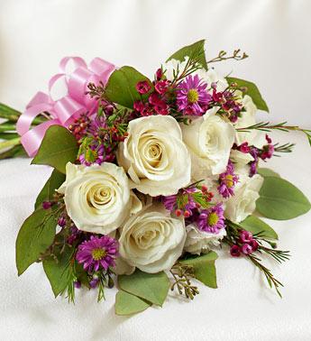 Bouquet of white roses and purple daisies tied with a pink ribbon