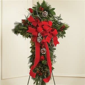 Tall holiday standing spray with red bows and pinecones