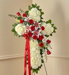 Standing floral spray with red roses, white blooms, and a red ribbon