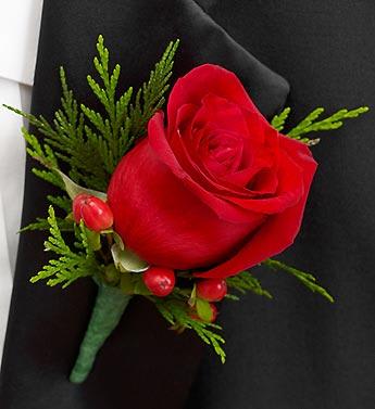 Red rose boutonniere with green foliage and berry accents