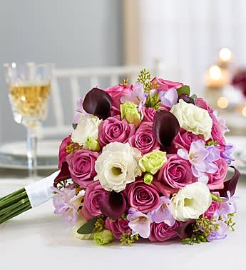 Bouquet of pink and white roses with dark calla lilies