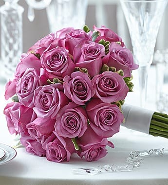 Bouquet of pink roses with a white ribbon wrap