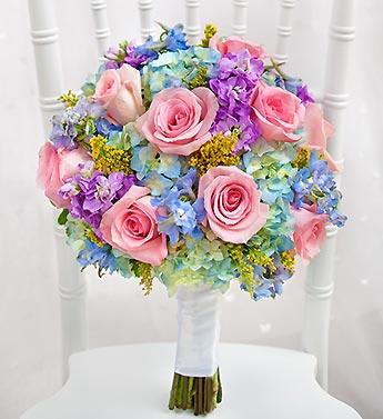 Round bouquet of pink roses and blue-purple flowers