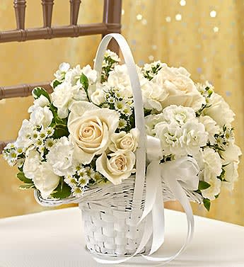 White rose bouquet in a white wicker basket with ribbon