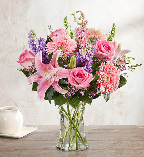Pink and purple mixed bouquet in a clear glass vase