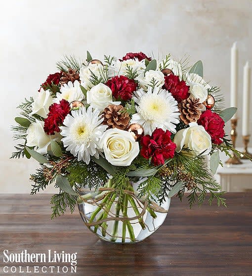 Red and white floral arrangement in a clear glass vase