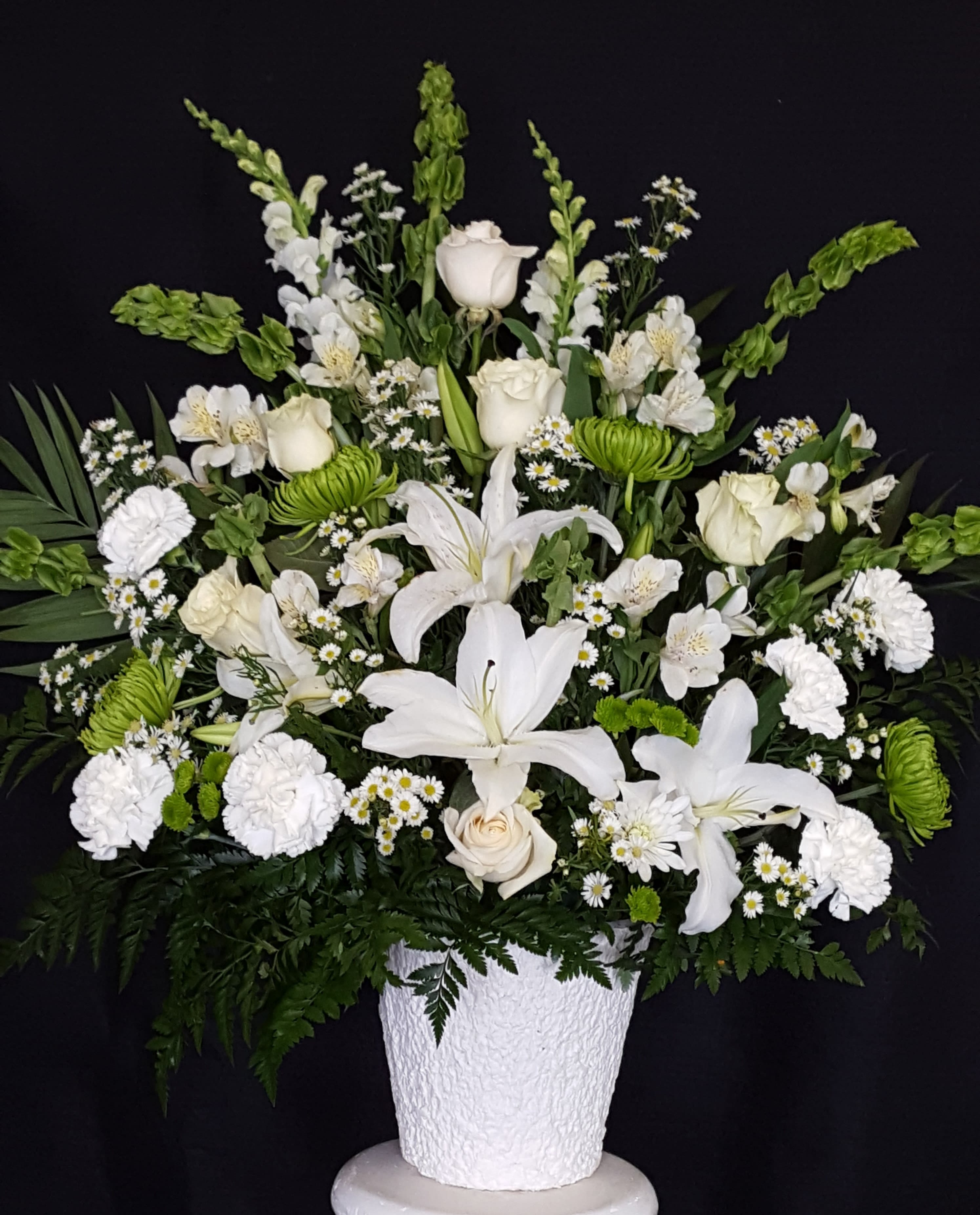 White floral arrangement in a textured white vase