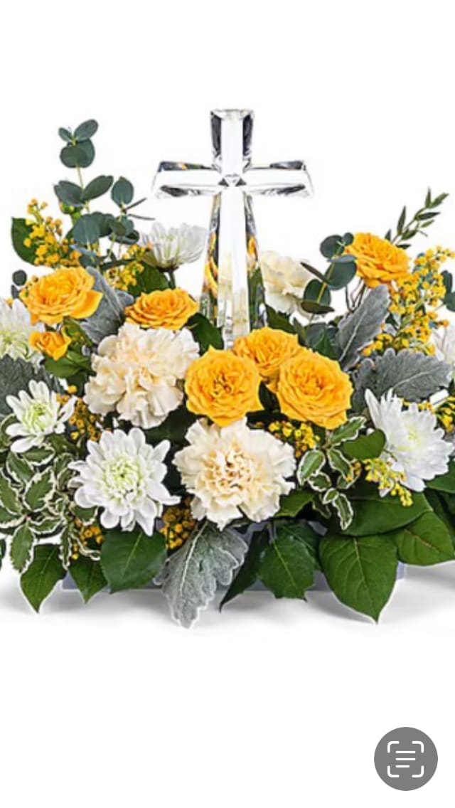 Yellow and white flower arrangement with a clear cross centerpiece